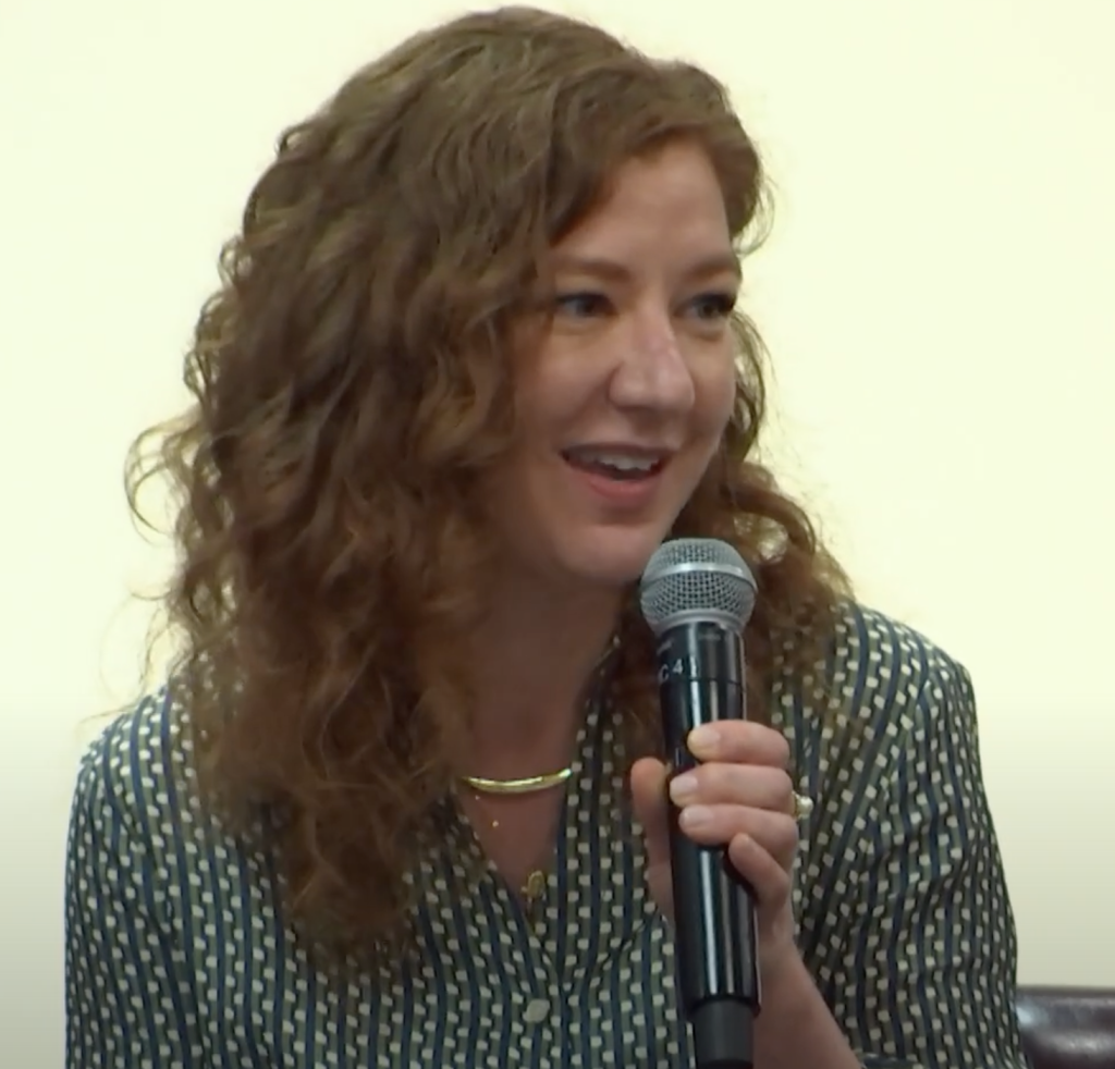 Redheaded young woman with a microphone